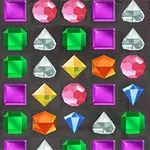 Joyas de diferentes colores y formas, como cuadrados, triángulos y diamantes, organizadas en una cuadrícula sobre un fondo oscuro