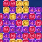 Bloques de colores con íconos de sombreros de mago, estrellas y moños en un diseño de cuadrícula sobre un fondo azul oscuro