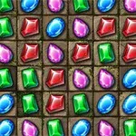 Gemas de colores rojo, verde, azul y rosa en una cuadrícula sobre un fondo texturizado