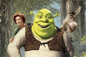 Un ogro verde sonriente junto a una mujer pelirroja y un burro, con un bosque de fondo