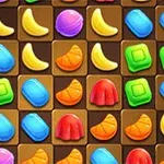 Mosaico de figuras de colores brillantes, como plátanos amarillos y gelatinas rojas, sobre un fondo marrón