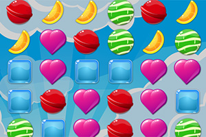 Dulces y frutas en forma de corazones rosados, rodajas de naranja, caramelos verdes y rojos, y cubos azules sobre un fondo azul con nubes