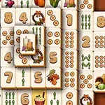 Azulejos con números, velas, hojas otoñales, y verduras en un diseño apilado sobre fondo marrón